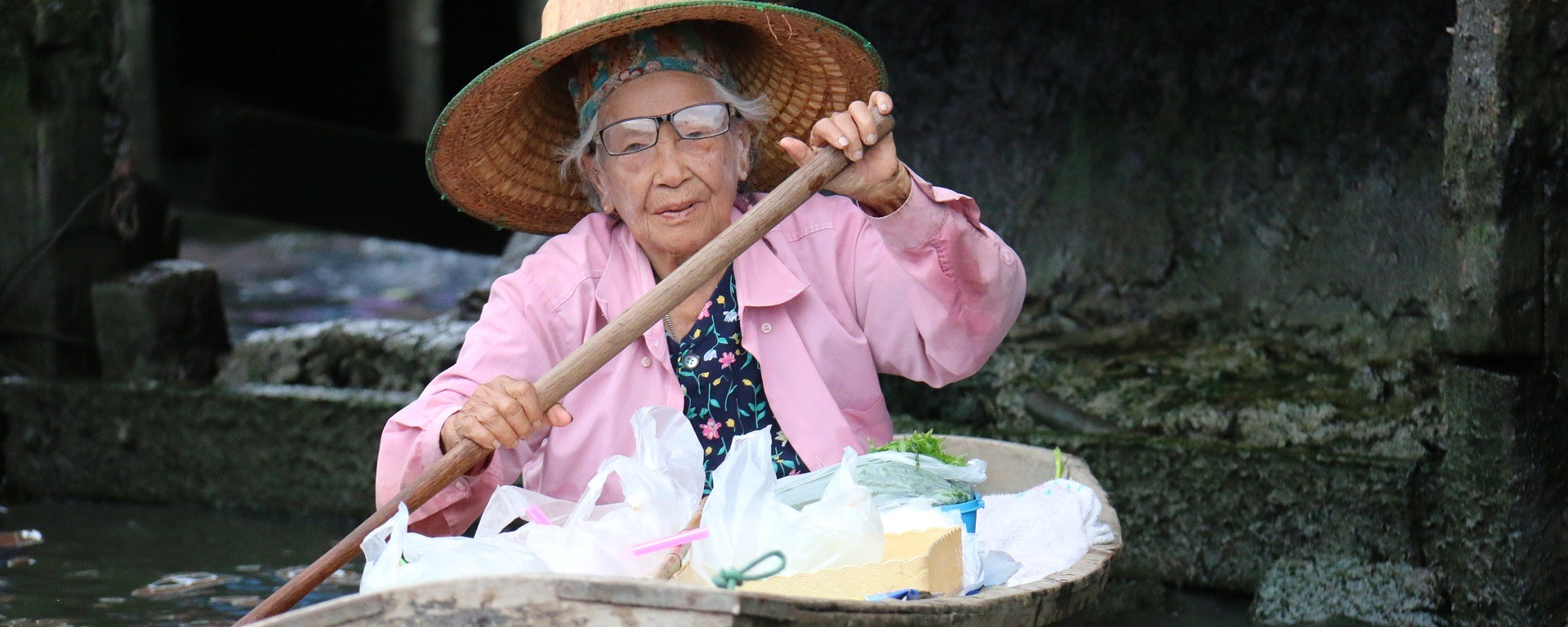 elderly woman,boat,vessel,courage,strength,age,paddling,channel,transport,pink,hat,old,river,cannal,hard life, DON CHARISMA
