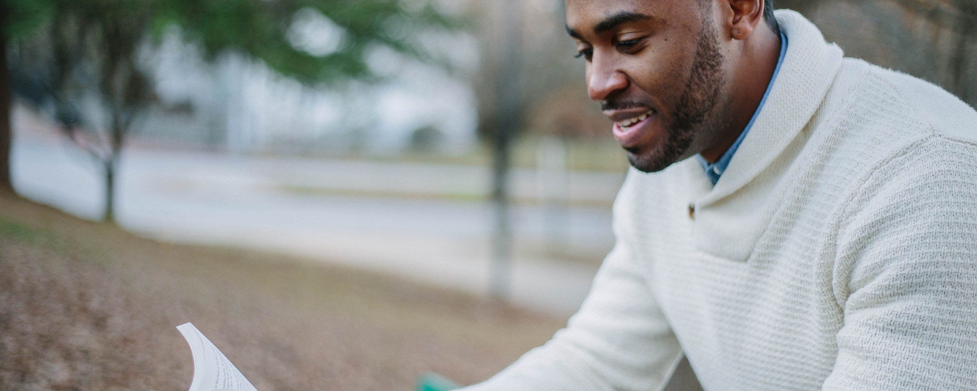 people,man,guy,smile,happy,reading,book,sitting,outside,black, DON CHARISMA